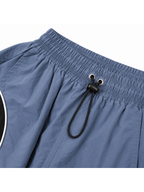 Pantalón Power Track Plomo — Tela Mojada | Mujer | ENKI - ENKI ModaStyle